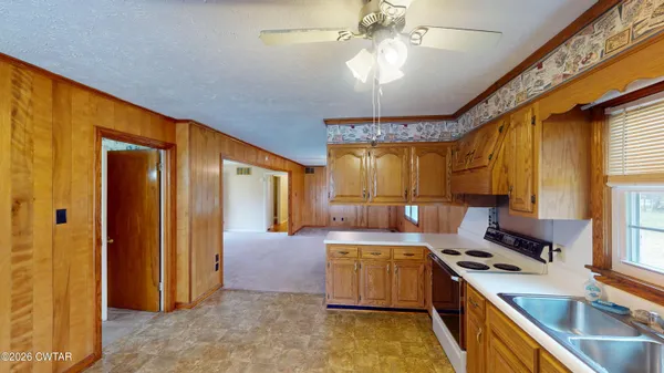 a kitchen that has a lot of cabinets in it and wooden floors