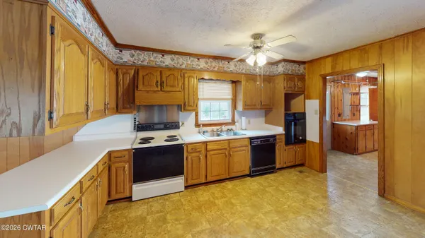 a large kitchen with a large window and stainless steel appliances