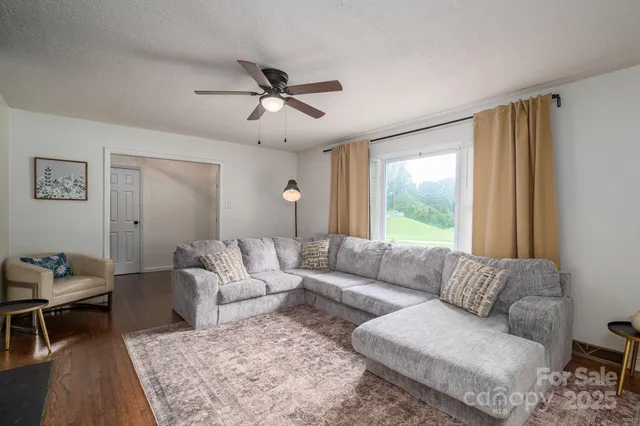 a living room with furniture and a large window