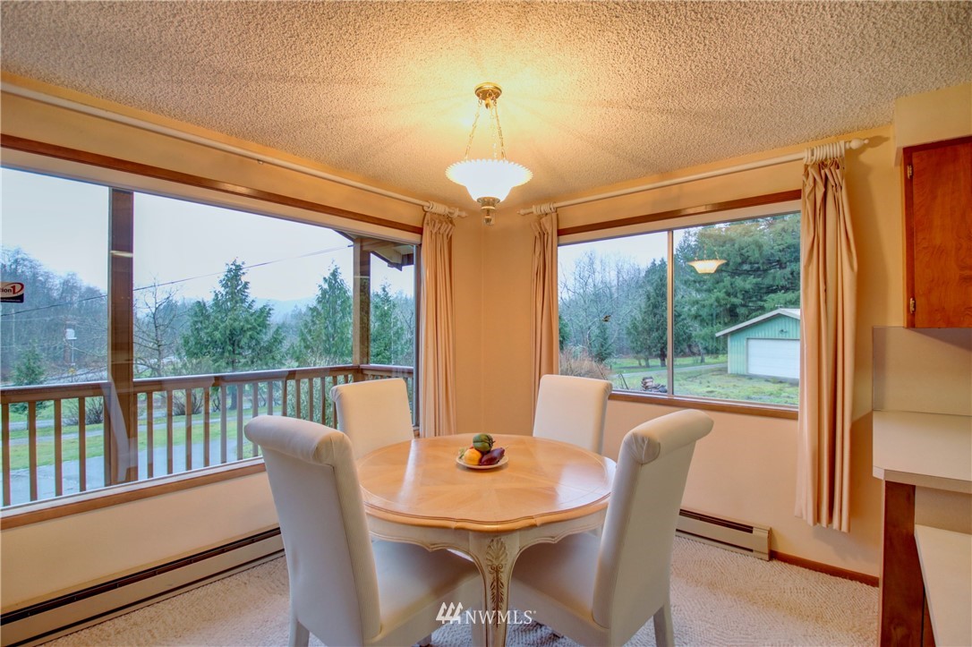 21889 Little Mountain Road Mount Vernon, WA 98274 - Photo 12 of 31 a view of a dining room with furniture window and outside view