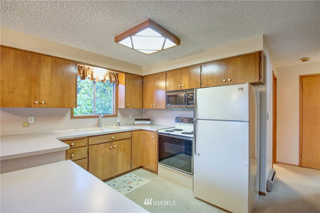 21889 Little Mountain Road Mount Vernon, WA 98274 - Photo 13 of 31 a kitchen with a sink a refrigerator and windows