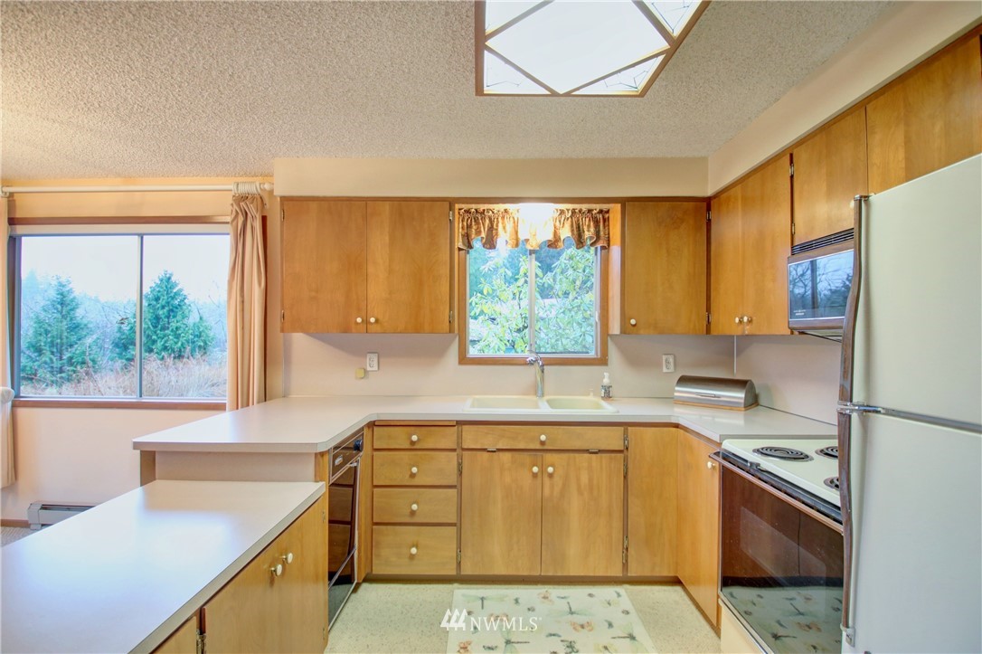 21889 Little Mountain Road Mount Vernon, WA 98274 - Photo 14 of 31 a kitchen with a cabinets a sink a stove and a window