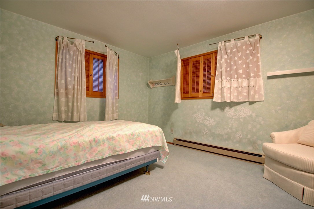 21889 Little Mountain Road Mount Vernon, WA 98274 - Photo 18 of 31 a bedroom with a bed and a couch