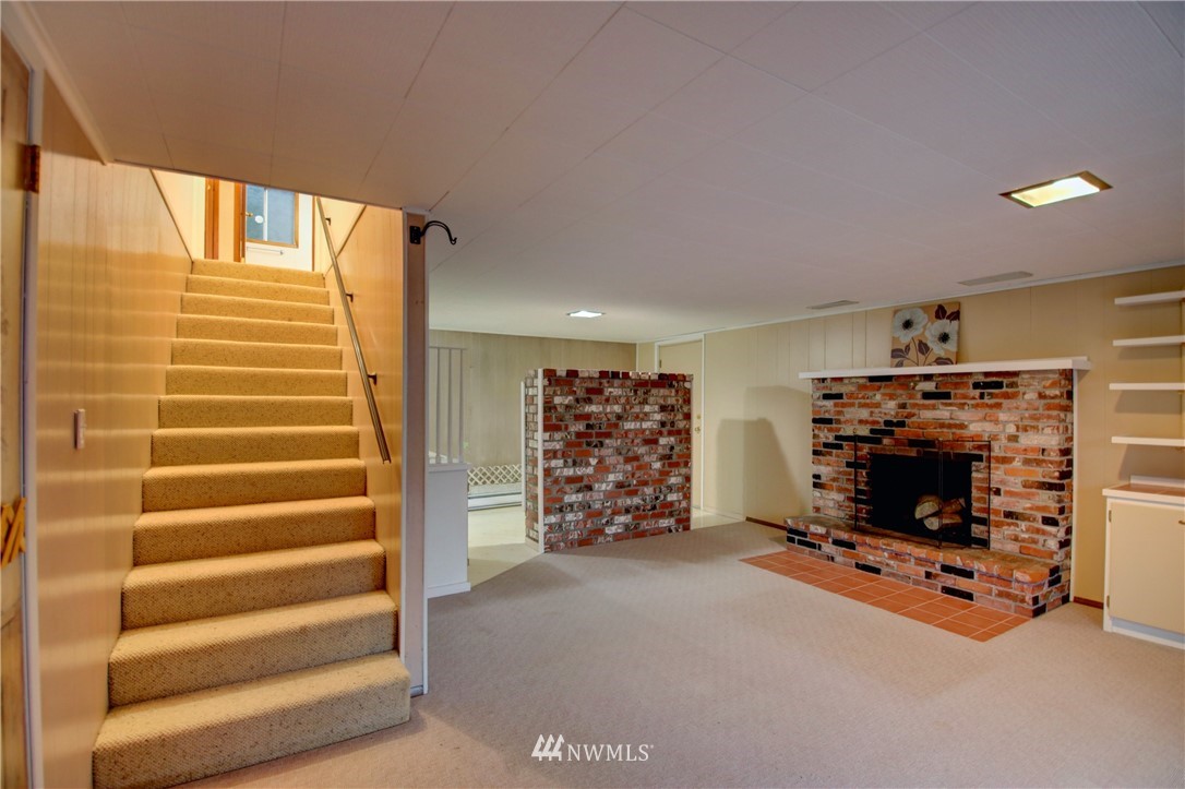 21889 Little Mountain Road Mount Vernon, WA 98274 - Photo 21 of 31 a view of an empty room with a fireplace and windows