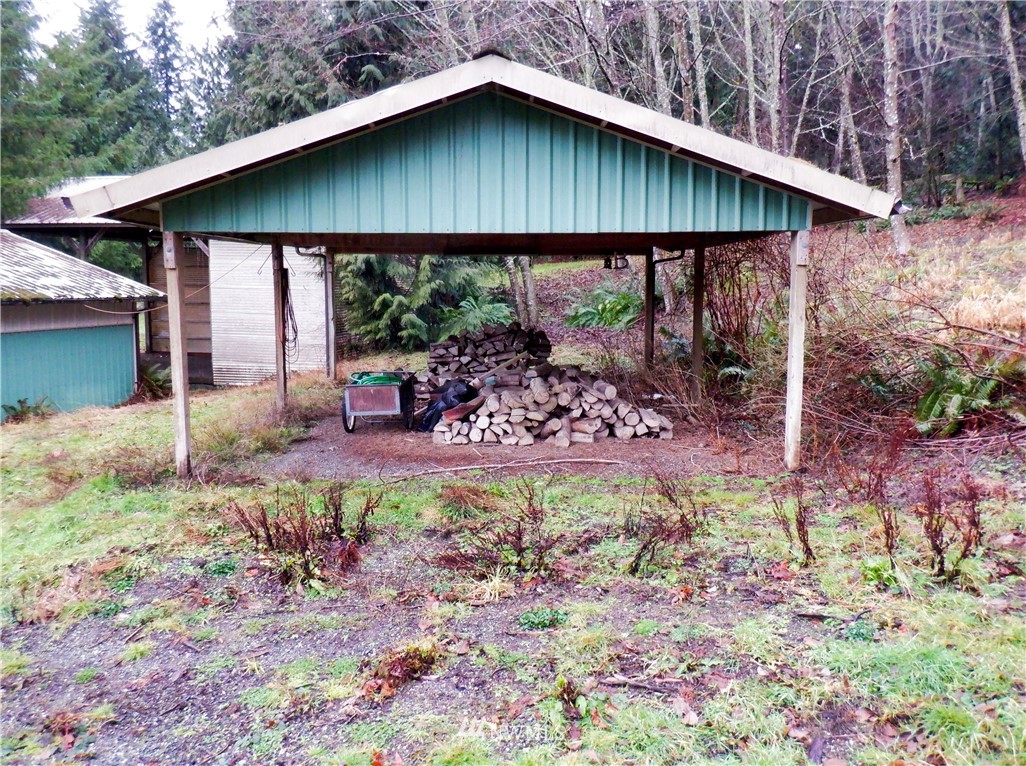 21889 Little Mountain Road Mount Vernon, WA 98274 - Photo 4 of 31 a backyard of a house with table and chairs under an umbrella