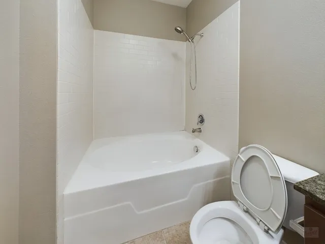 a bathroom with a bathtub and a window