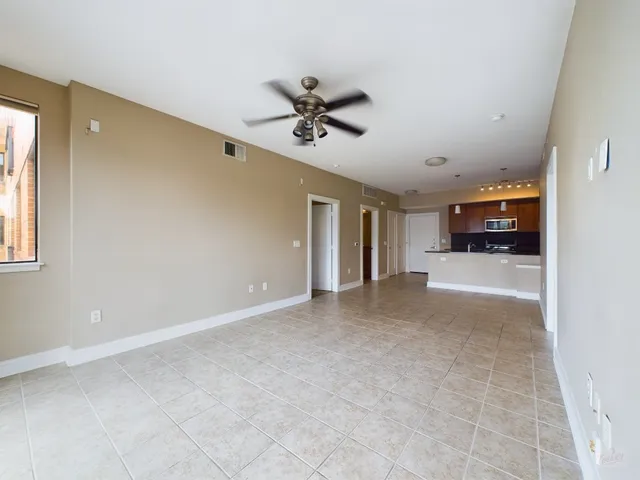 a view of a livingroom with a ceiling fan and window
