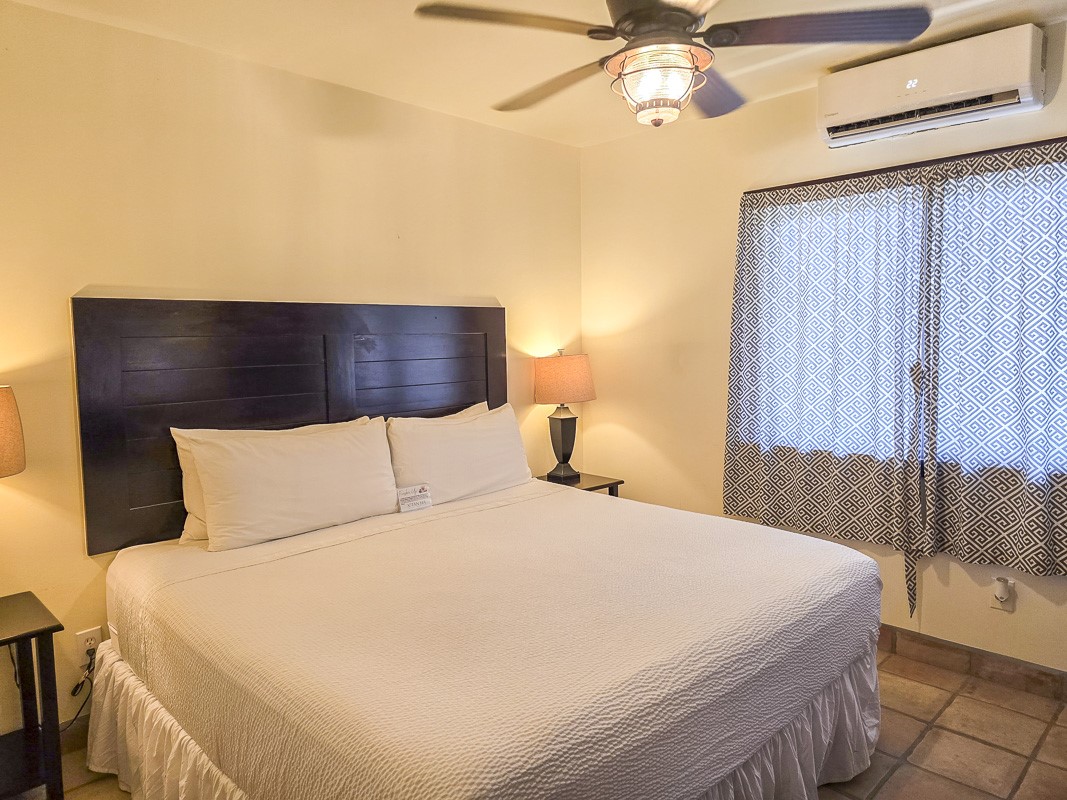 0 X’tan Ha Garden, Unit GV 15 Robstown, TX 78380 - Photo 8 of 22 a bedroom with a bed and a chandelier