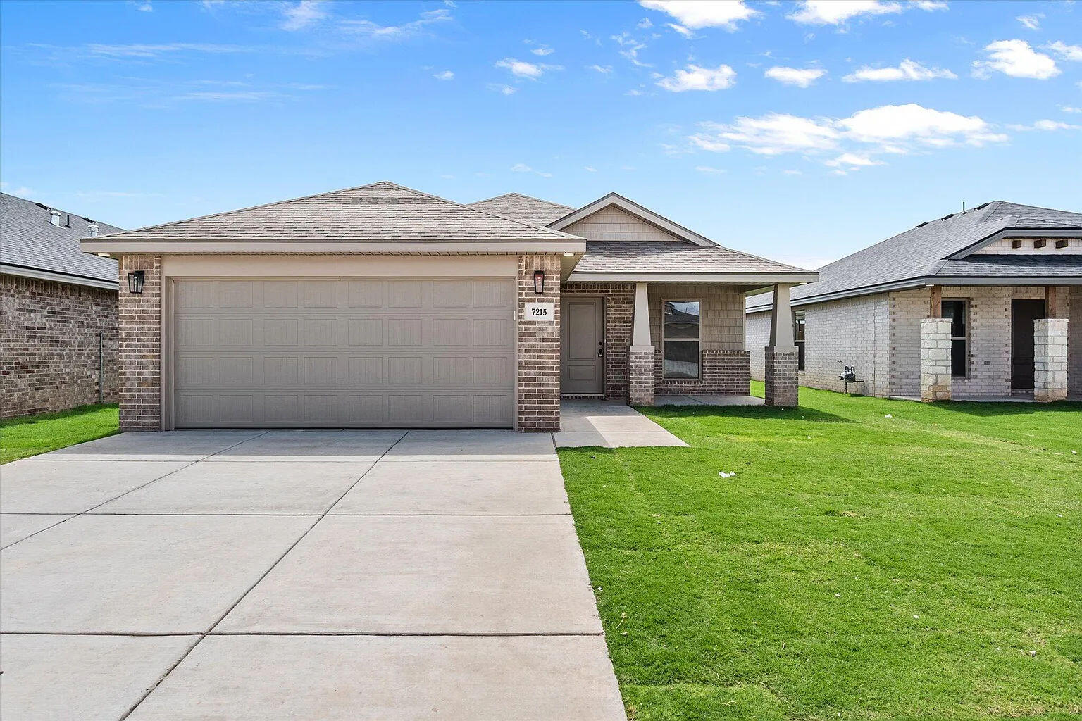 a front view of a house with a garden and yard