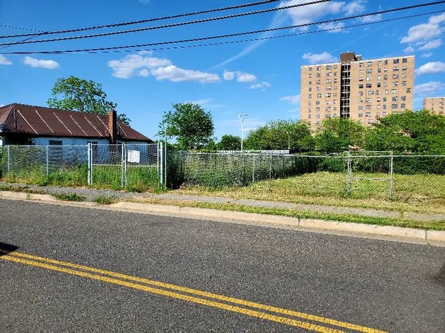 a view of a house with a yard and a street