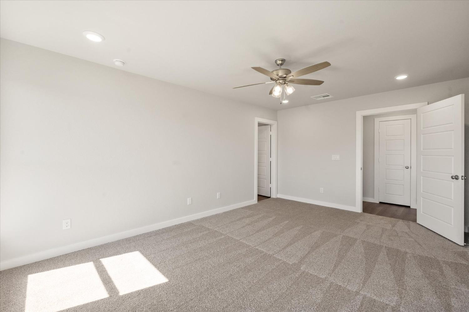 7007 9th Street Lubbock, TX 79416 - Photo 14 of 22 wooden floor in an empty room with a window