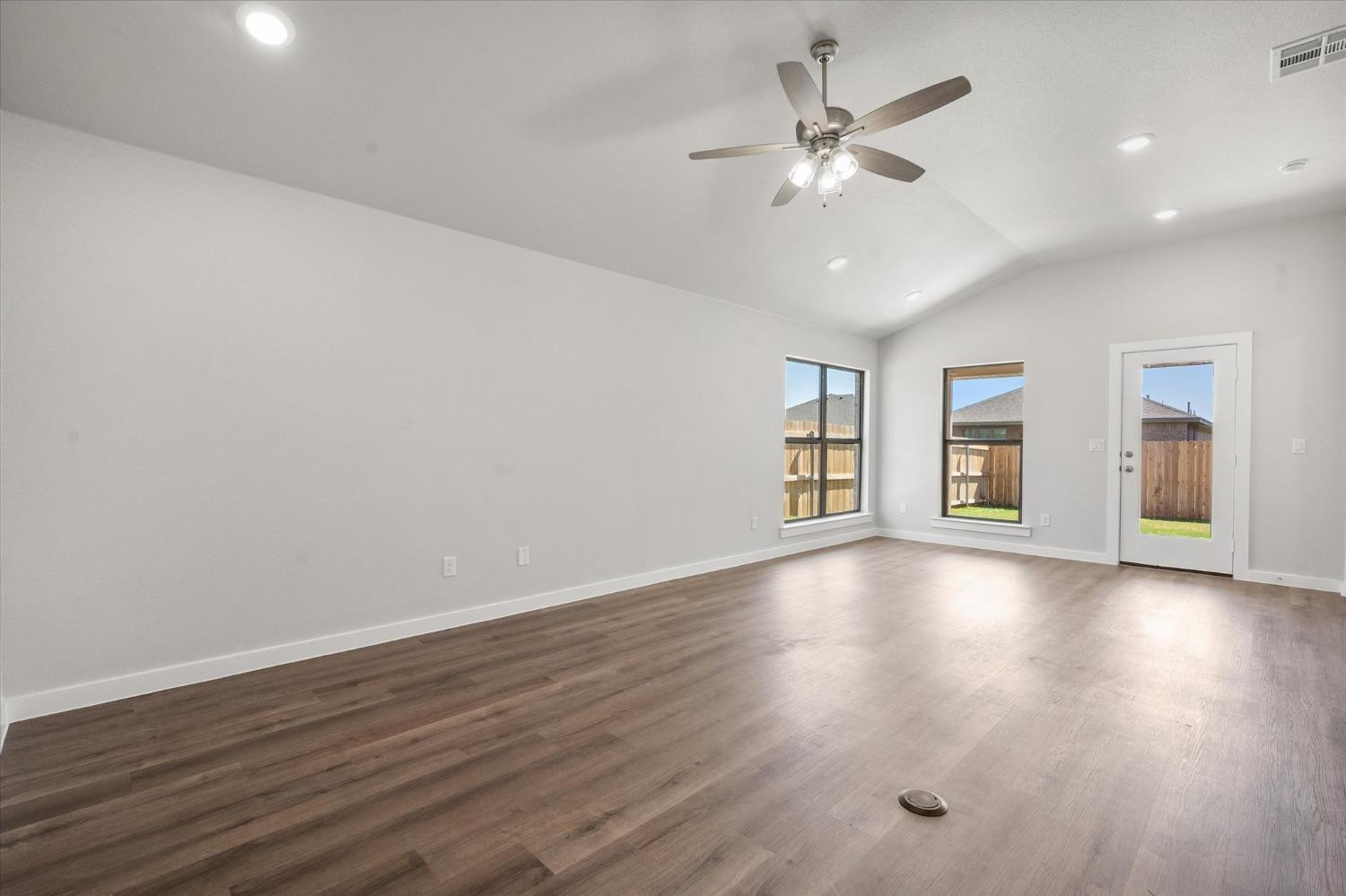 7007 9th Street Lubbock, TX 79416 - Photo 3 of 22 a view of an empty room with window and wooden floor