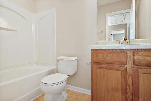 a bathroom with a granite countertop toilet a sink and bathtub