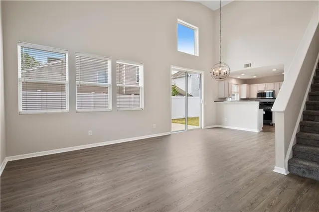 a view of a kitchen with a sink wooden floor and a large window