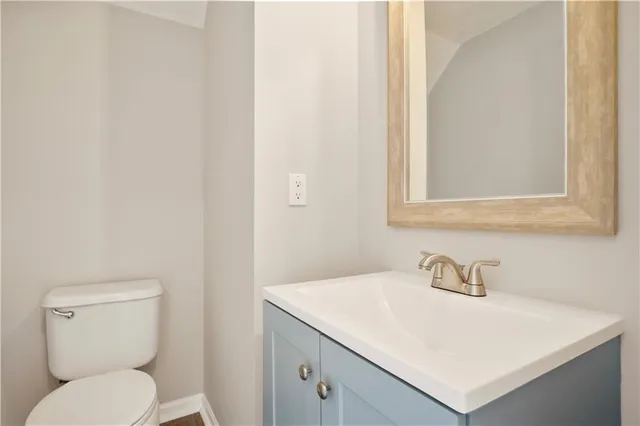 a white toilet sitting next to a bathroom sink