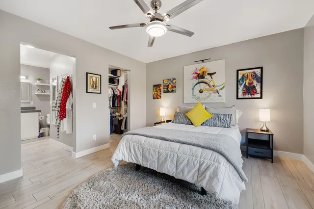 a bedroom with a bed and a chandelier