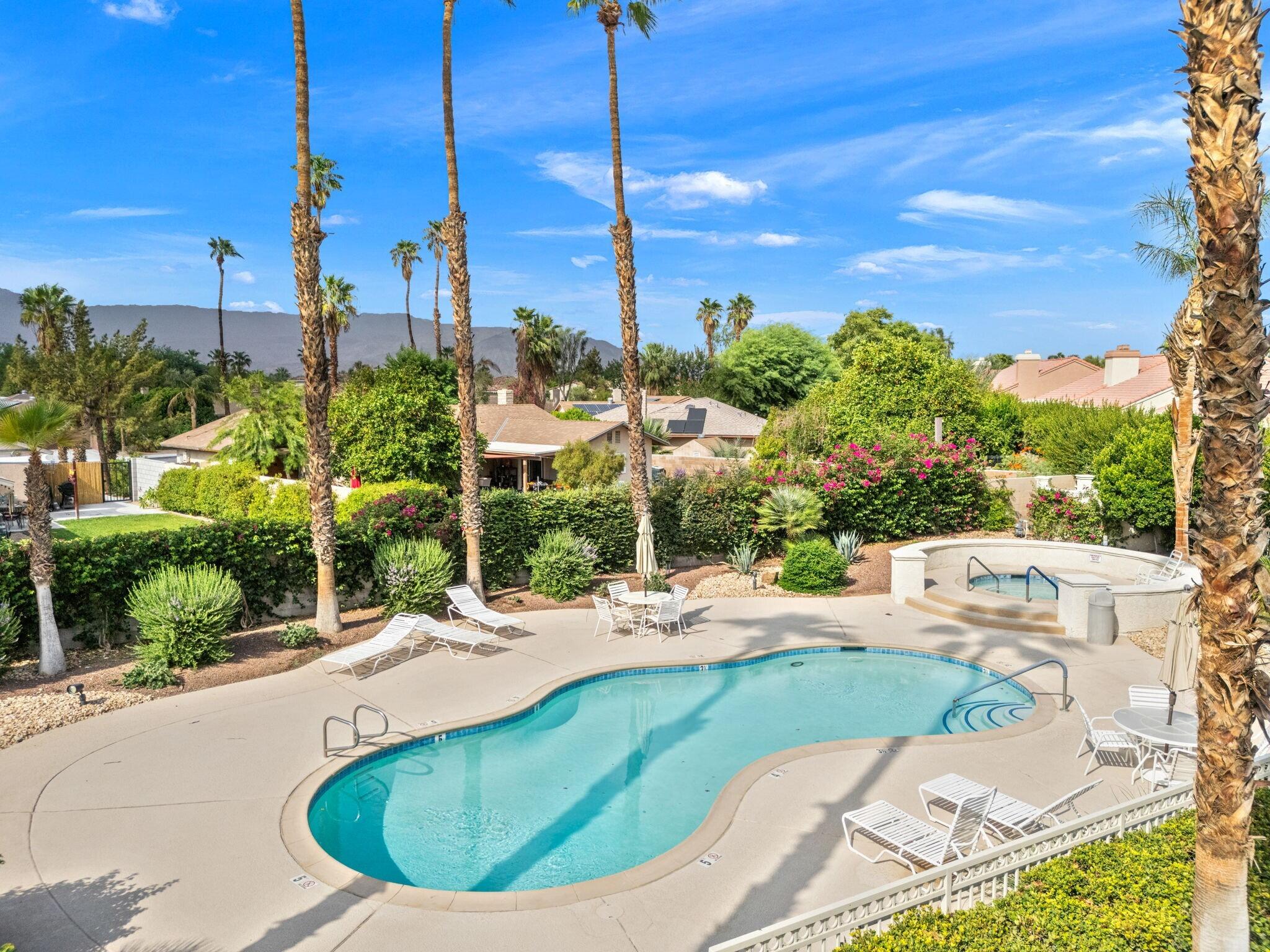 42831 Scirocco Road Palm Desert, CA 92211 - Photo 21 of 32 a view of a swimming pool with a sitting area