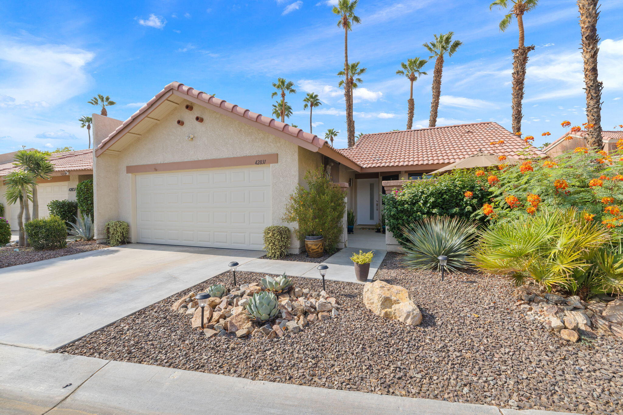 42831 Scirocco Road Palm Desert, CA 92211 - Photo 23 of 32 a front view of a house with garden
