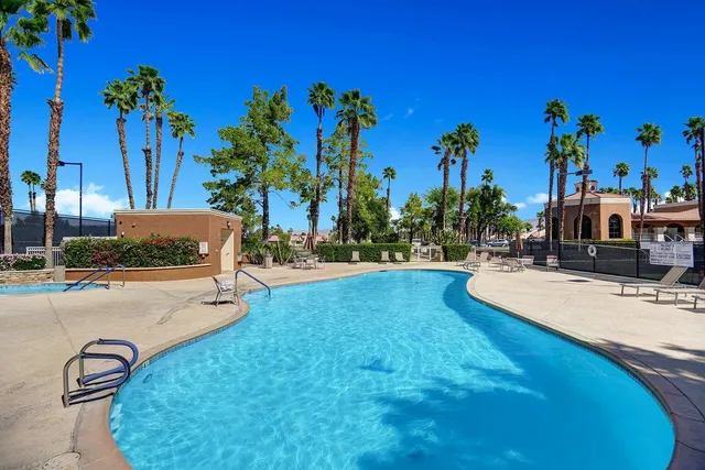 a swimming pool with outdoor seating and yard