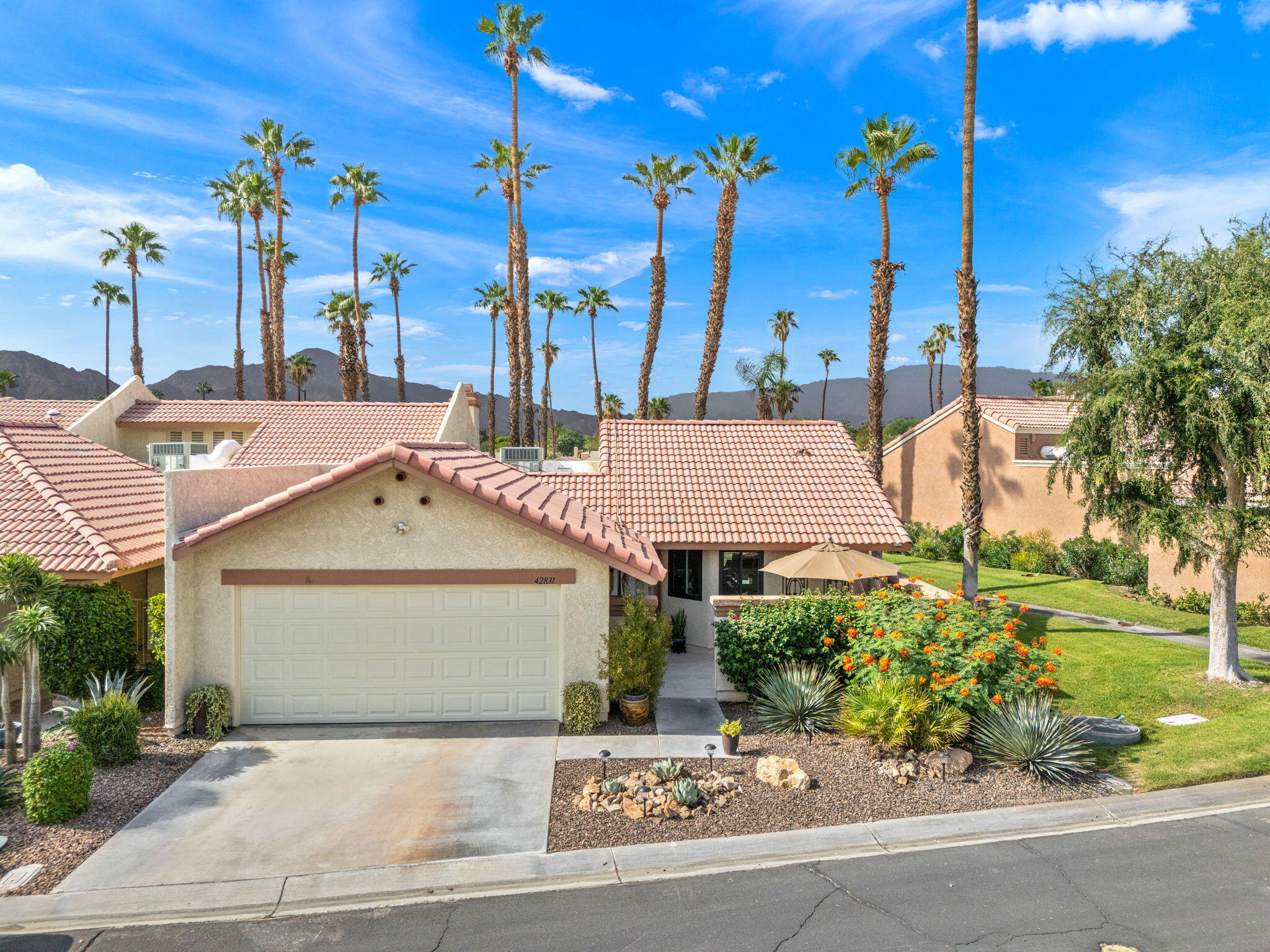 42831 Scirocco Road Palm Desert, CA 92211 - Photo 3 of 32 a view of a house with a yard and potted plants