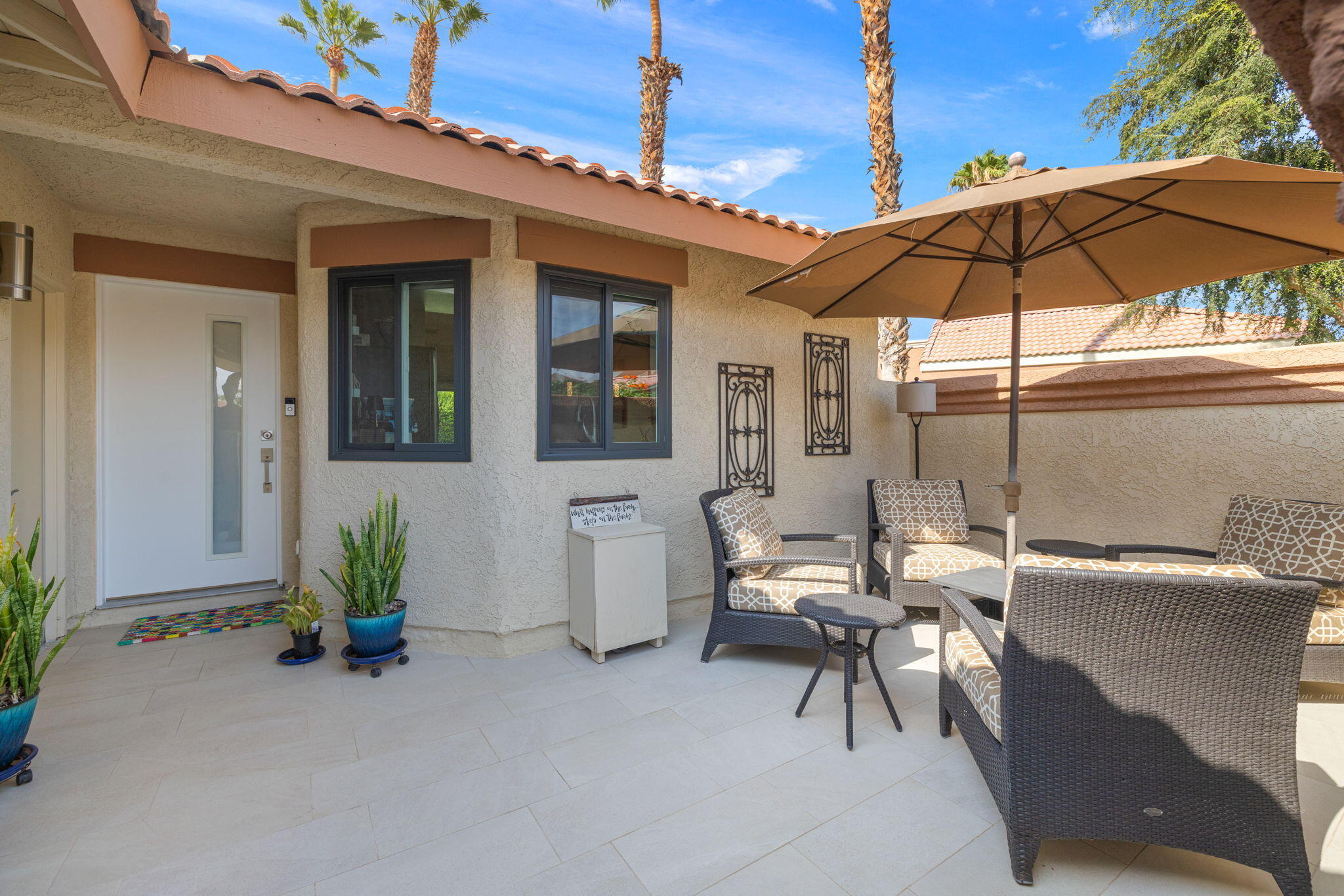 42831 Scirocco Road Palm Desert, CA 92211 - Photo 4 of 32 a view of a patio with table and chairs under an umbrella