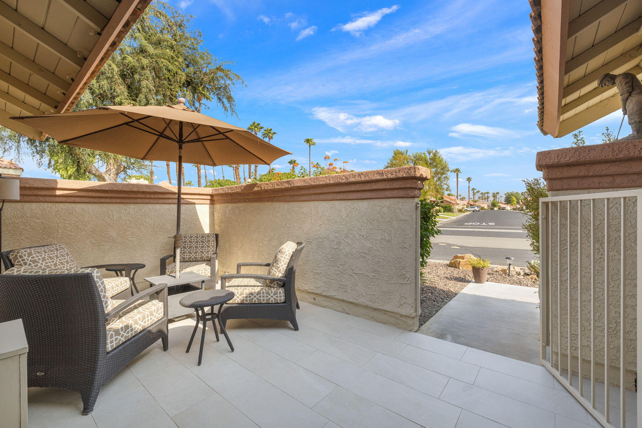 42831 Scirocco Road Palm Desert, CA 92211 - Photo 5 of 32 a view of a terrace with furniture and an umbrella