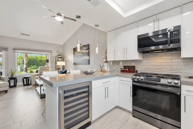a kitchen with stainless steel appliances a stove a sink and a microwave