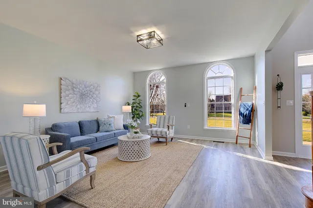 a living room with furniture large window and a fireplace