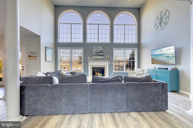 a kitchen with stainless steel appliances granite countertop a table chairs sink refrigerator and cabinets