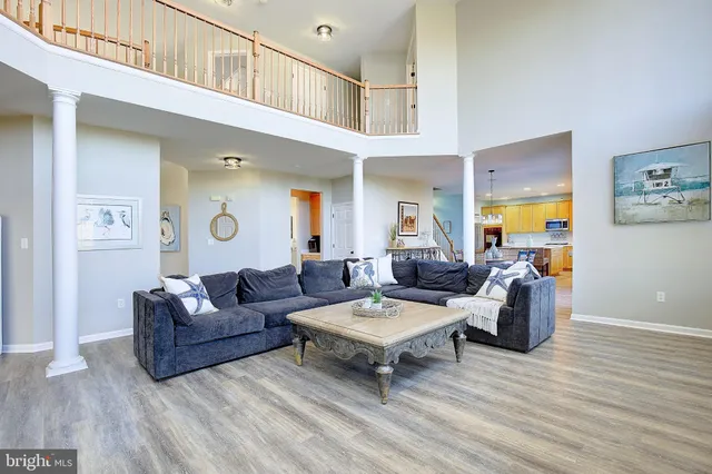 a kitchen with a stove a refrigerator and a dining table with wooden floor