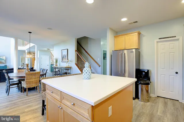 a view of a hallway with wooden floor and windows