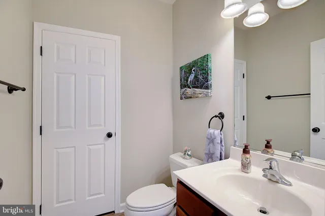a living room with furniture and a ceiling fan