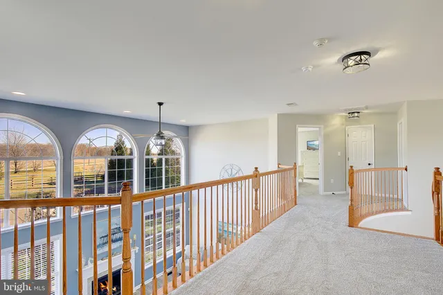 a spacious bedroom with a bed and a large window