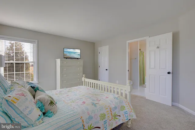 a large spacious bathroom with a tub a sink and mirror