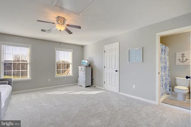 an aerial view of a house with backyard space and swimming pool