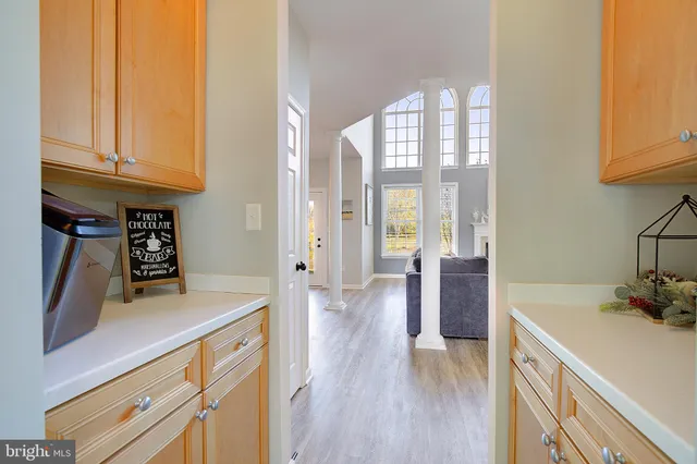 a living room with furniture a fireplace and a large window