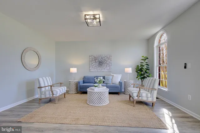 a living room with furniture a fireplace and a large window