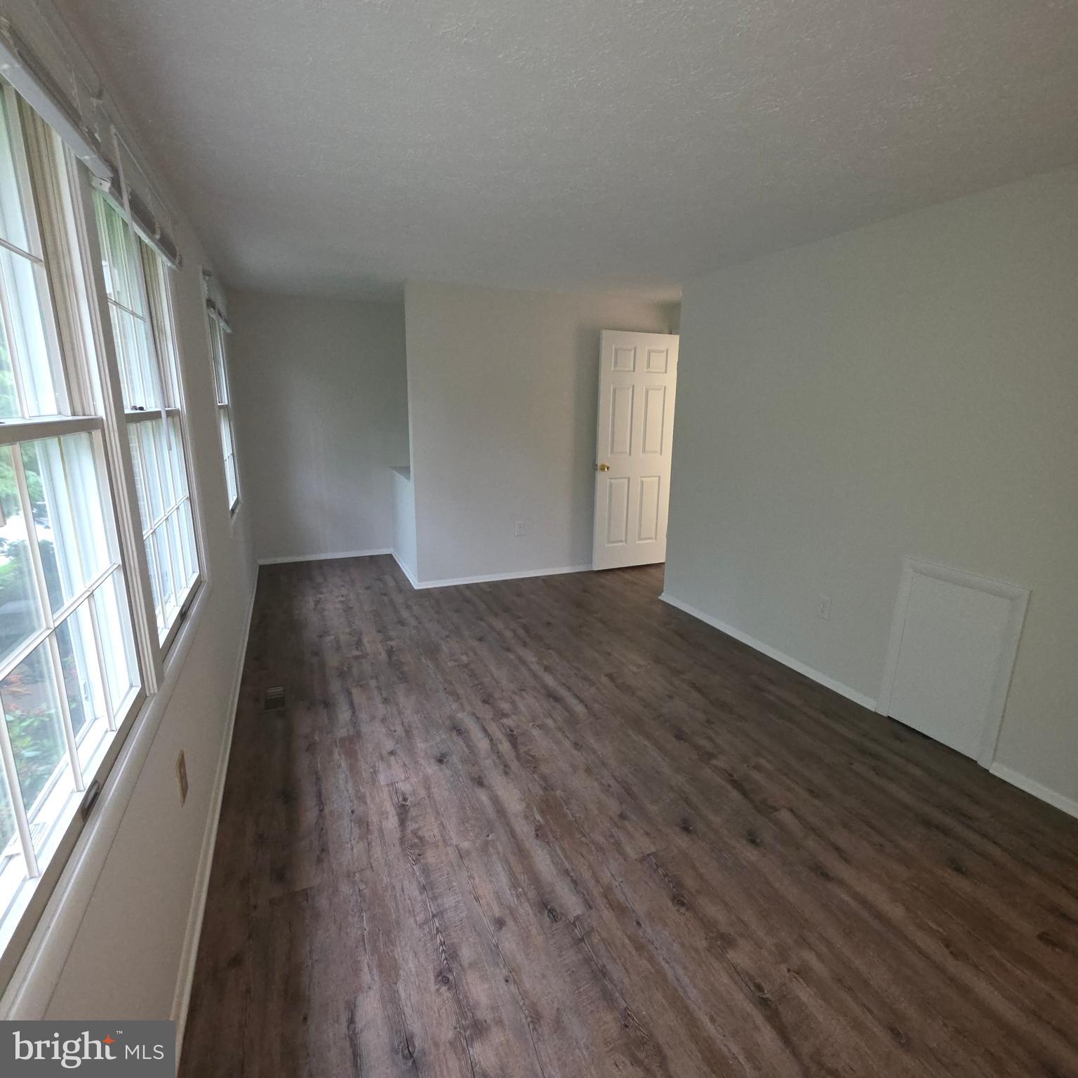 1758 Springfield Lane Frederick, MD 21702 - Photo 25 of 31 an empty room with wooden floor and windows