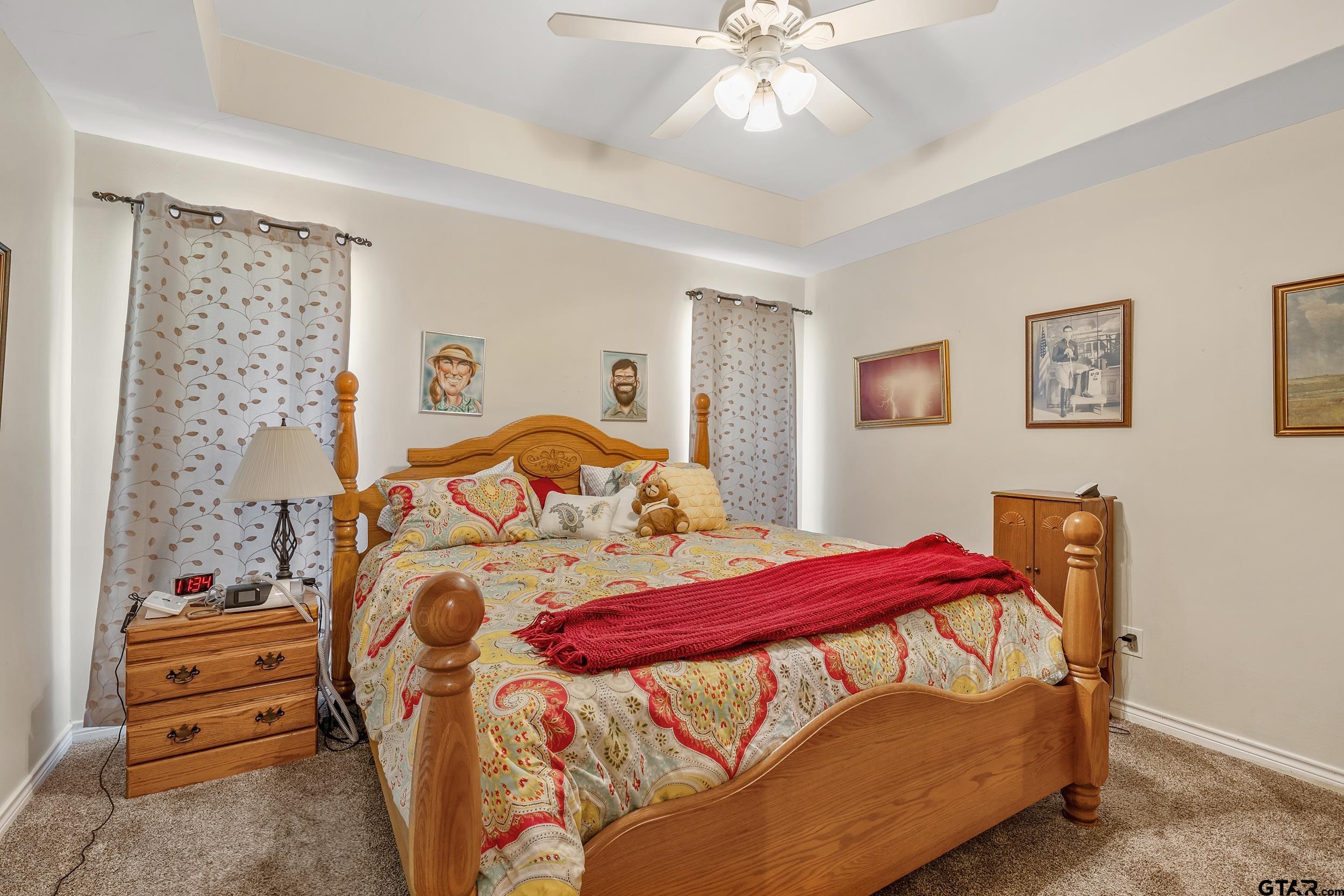 18054 Silver Leaf Flint, TX 75762 - Photo 13 of 30 a bedroom with a bed and a chandelier