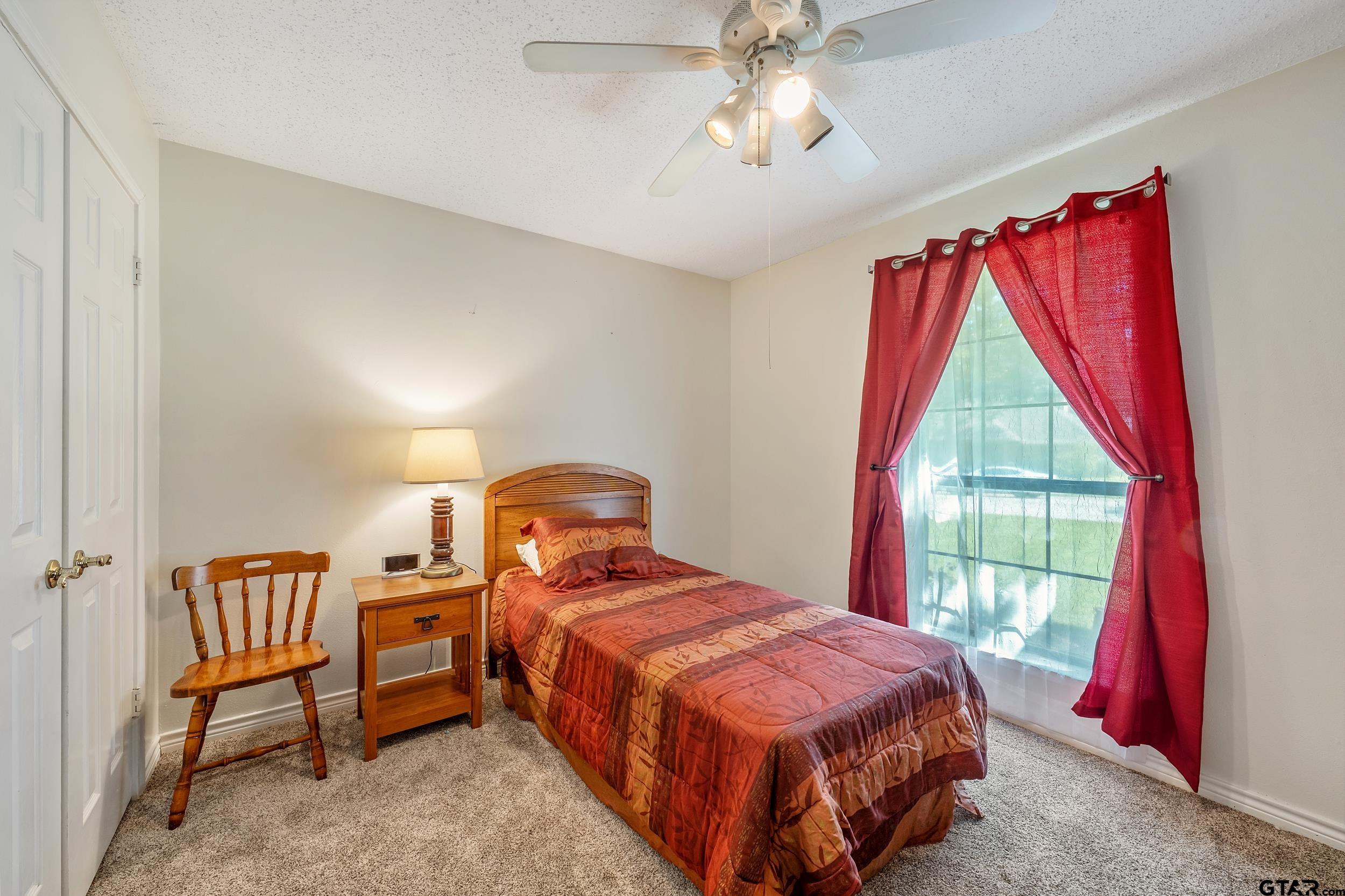 18054 Silver Leaf Flint, TX 75762 - Photo 16 of 30 a bed room with a bed and a chair