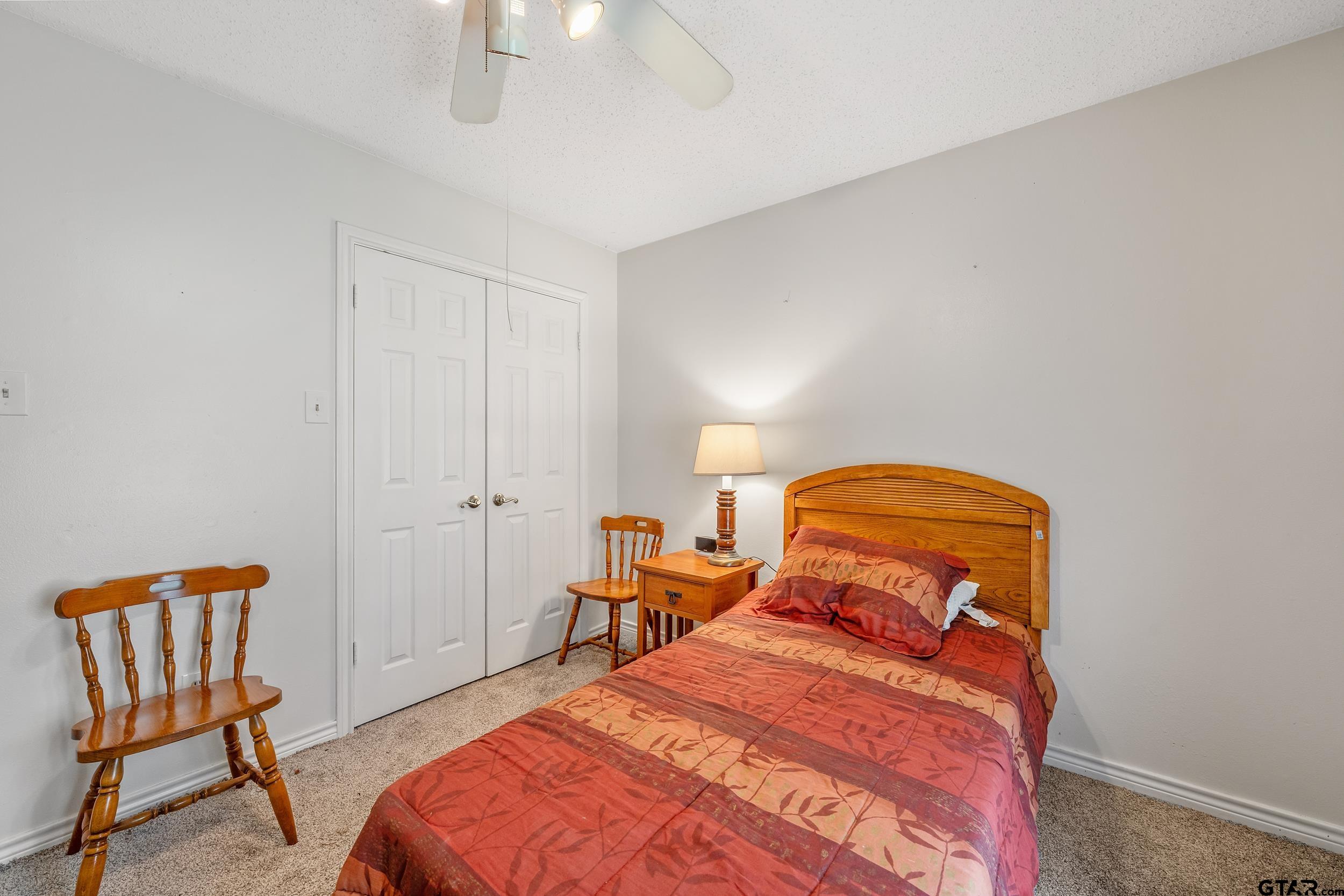 18054 Silver Leaf Flint, TX 75762 - Photo 17 of 30 a bedroom with a bed and chair