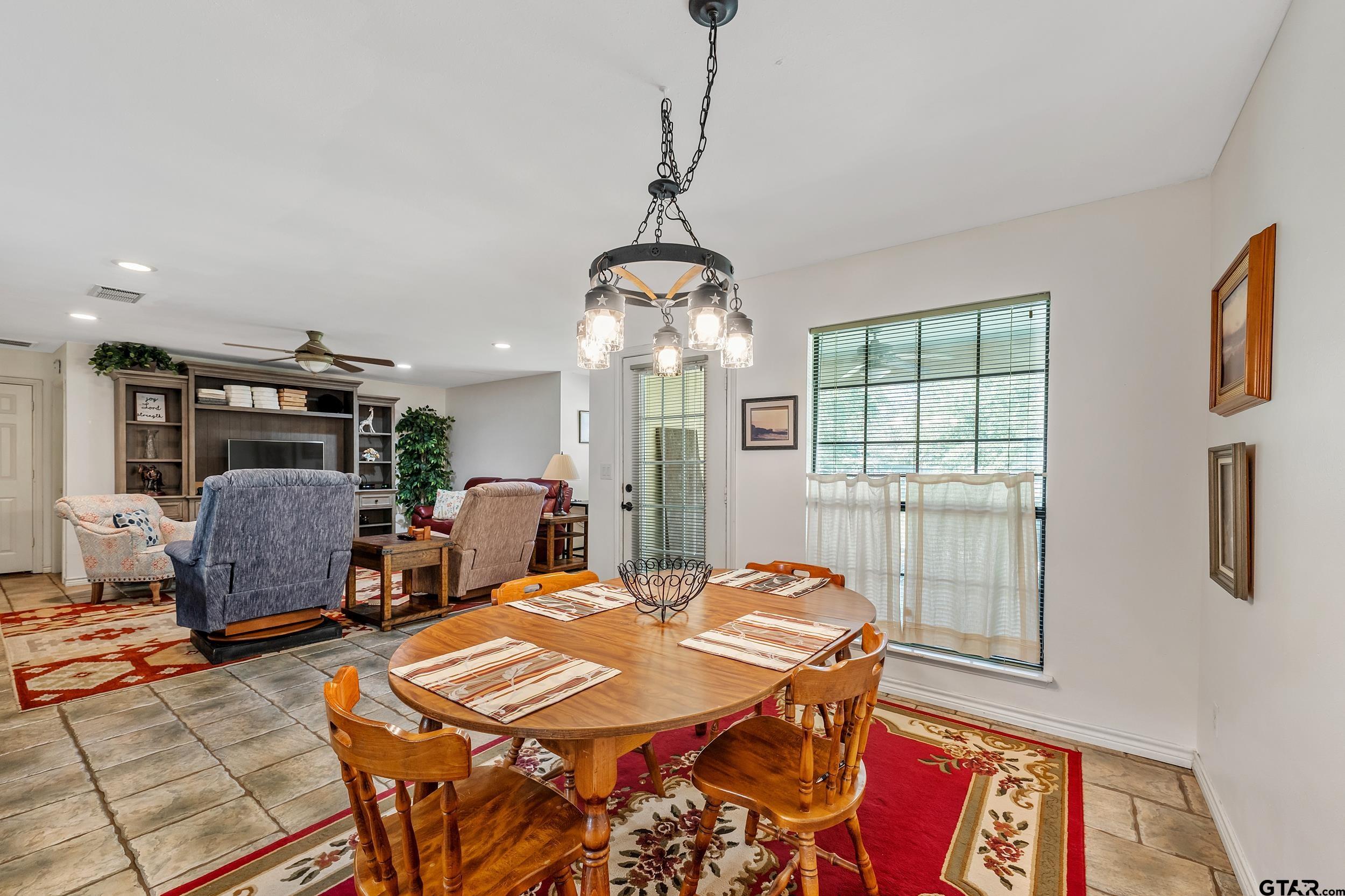 18054 Silver Leaf Flint, TX 75762 - Photo 6 of 30 a dining room with furniture a chandelier and window
