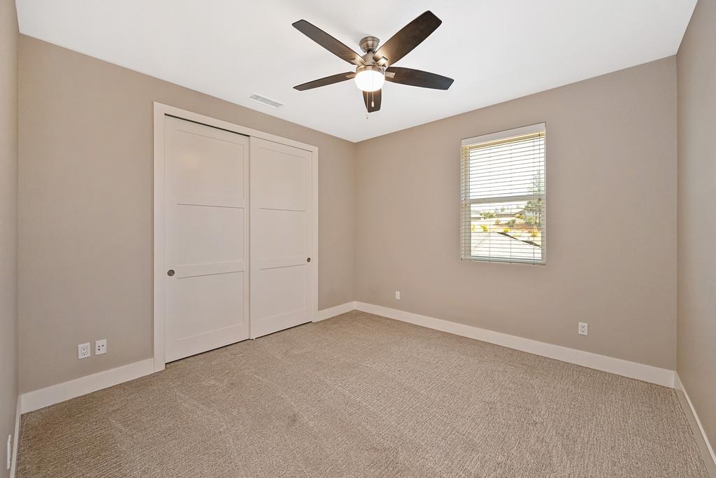 504 Chase Court Colfax, CA 95713 - Photo 72 of 94 an empty room with a window and a ceiling fan