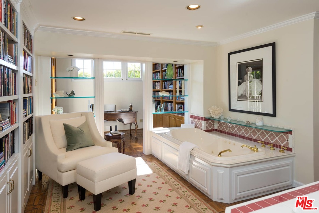 1027 Summit Drive Beverly Hills, CA 90210 - Photo 14 of 23 a white bath tub sitting next to a white chair and table