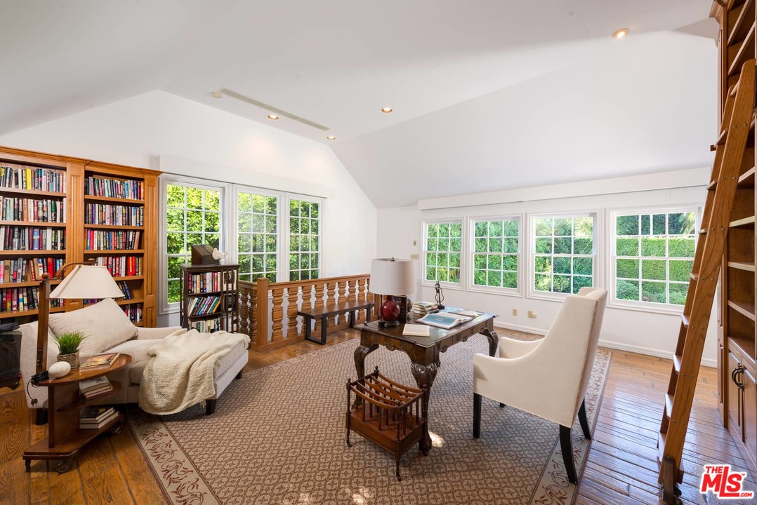 1027 Summit Drive Beverly Hills, CA 90210 - Photo 17 of 23 a bedroom with furniture and a large window