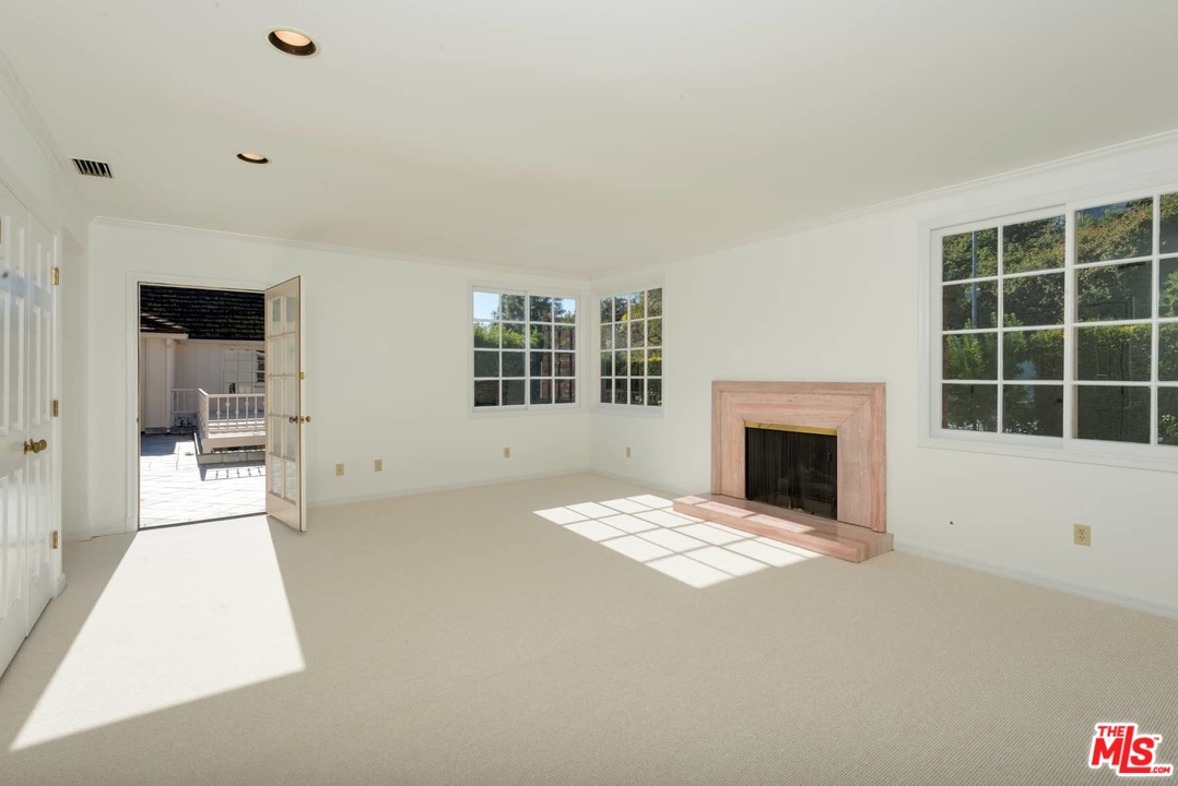 1027 Summit Drive Beverly Hills, CA 90210 - Photo 19 of 23 a view of an empty room with a window