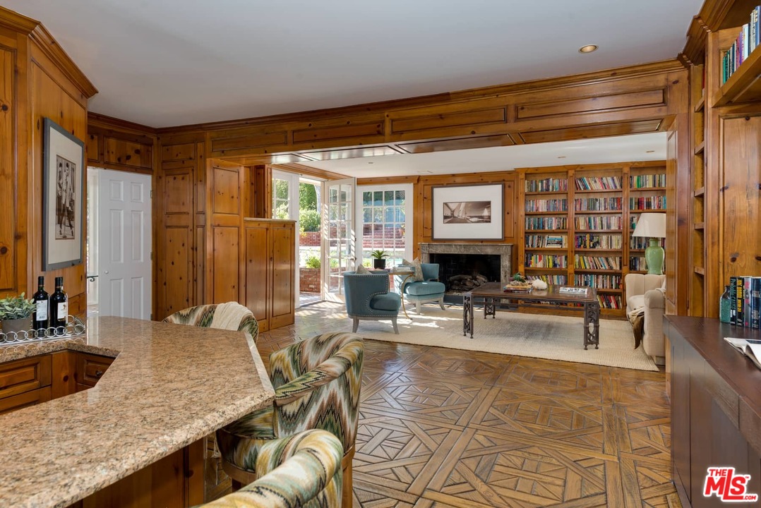 1027 Summit Drive Beverly Hills, CA 90210 - Photo 6 of 23 a living room with furniture and large window