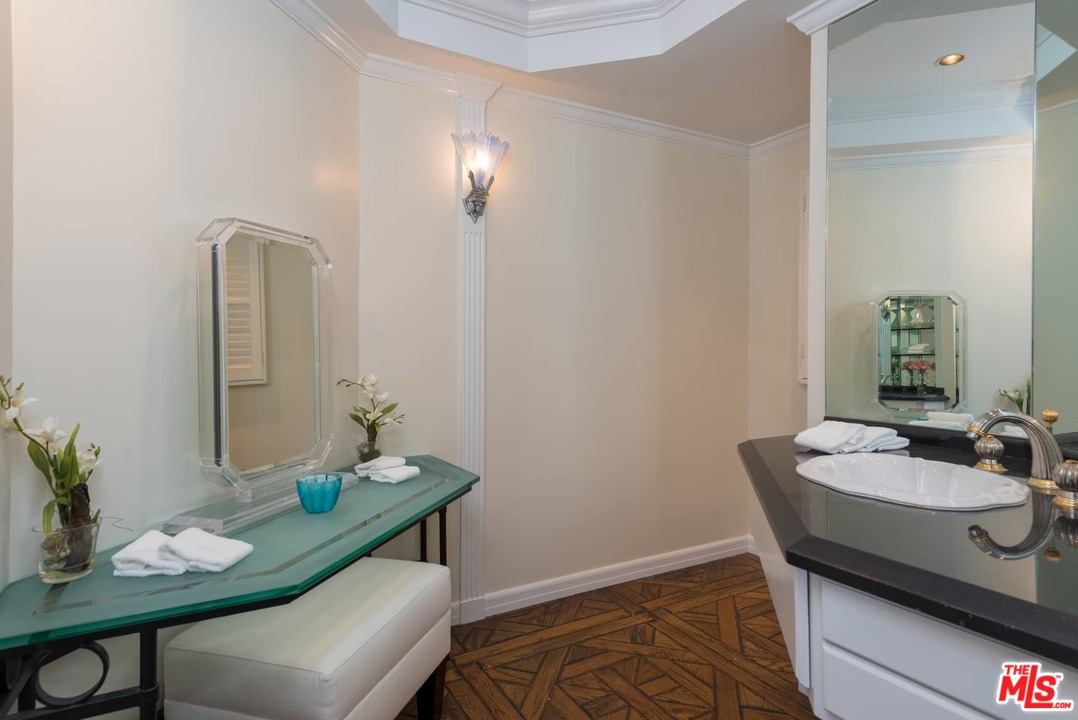 1027 Summit Drive Beverly Hills, CA 90210 - Photo 7 of 23 a dining room with furniture and wooden floor