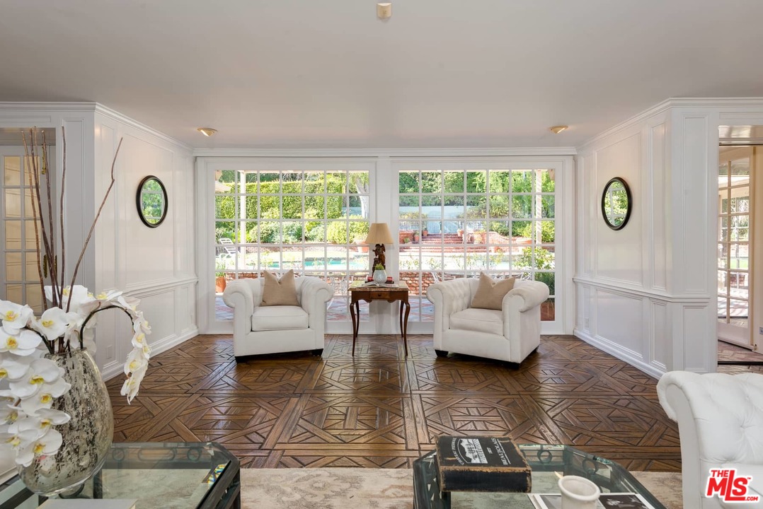 1027 Summit Drive Beverly Hills, CA 90210 - Photo 8 of 23 a living room with fireplace furniture and a large window