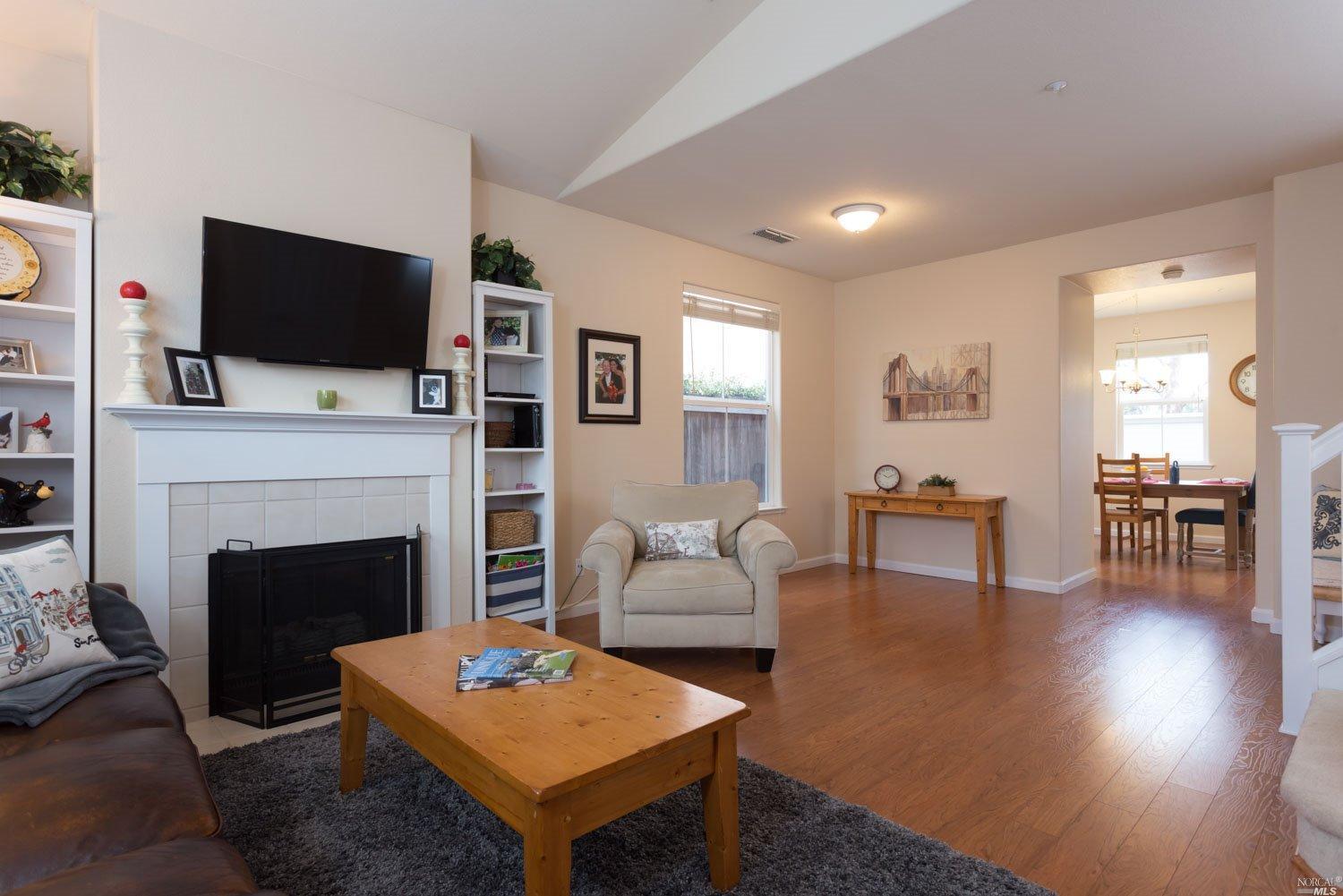 98 Gann Way Novato, CA 94949 - Photo 1 of 1 a living room with furniture a fireplace and a flat screen tv